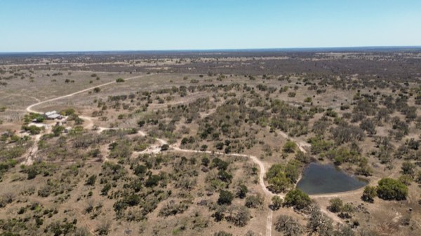 Aerial view of ranch country cut by a dry creek bed